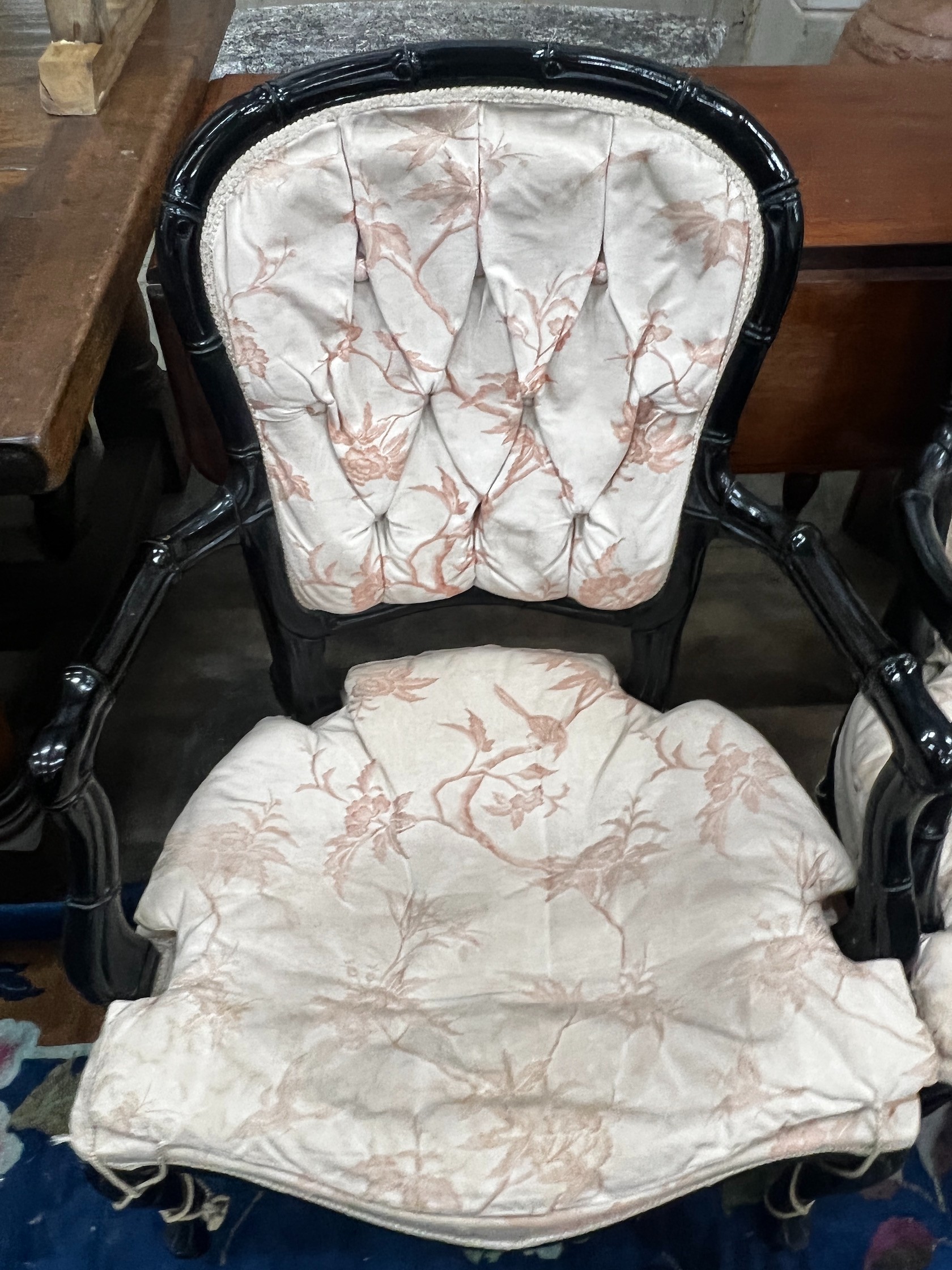 A pair of ebonised faux bamboo elbow chairs, width 58cm depth 50cm height 90cm